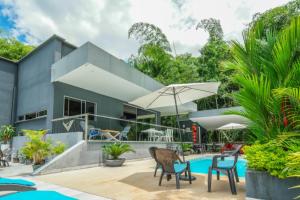 a house with a swimming pool and chairs at CASA LUZ Hospedaje, Pereira , Cerritos in Pereira