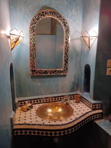 a bathroom with a sink and a mirror at Riad El Filali in Marrakesh