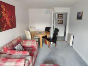 a living room with a couch and a table at Station View in Oban