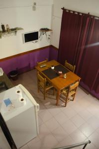 a dining room with a table and a tv at Espacio Infinito in Capilla del Monte