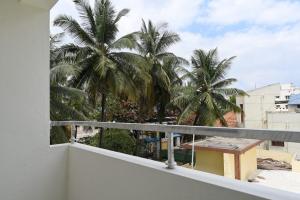 a view of palm trees from a balcony at DivBnK homes Bangalore in Bangalore