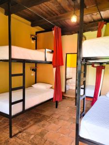 a room with four bunk beds in a hostel at Hostel Hopa Antigua in Antigua Guatemala
