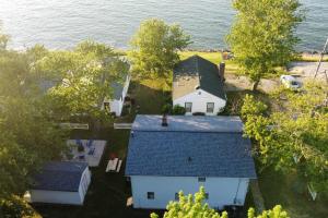 an aerial view of a house with a blue roof at 5 Bedroom Lakeside Home Sleeps 12 - Shared Lake Access, Large Yard, Central Air, Fire Pit, Horseshoes & More! in Geneva
