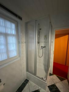 a shower stall in a bathroom with a window at Gaststätte & Pension Waldschlösschen in Oberhof