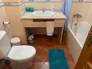 Un baño con lavabo, inodoro y bañera. en t2 armação de pêra, en Armação de Pêra