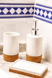 a bathroom with two toilet paper dispensers on a counter at Beach House Haller in Aljezur