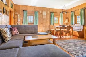 a living room with a couch and a table at Bauernhof Lehengut in Pfarrwerfen