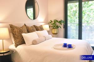 a bedroom with a white bed with a table on it at Mediterranean Barcelona Apartments in Barcelona