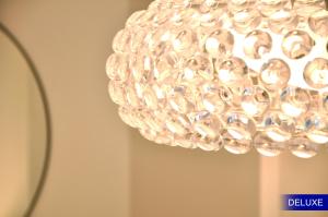 a clear chandelier hanging from a ceiling at Mediterranean Barcelona Apartments in Barcelona