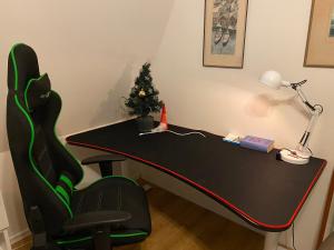 a black desk with a christmas tree and a lamp at Family and Business Bed and Breakfast with a Beautiful Garden in Kallfors, Stockholm near a Golf Course, Lakes, the Baltic Sea, Forests & Nature in Järna