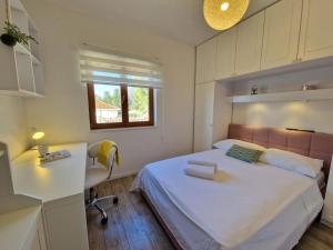 a bedroom with a bed and a desk and a chair at Apartment Ivana in Trogir