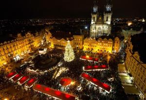 a christmas tree in the middle of a city at night at Pension Lucie in Prague