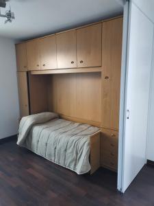 a bedroom with a bed and wooden cabinets at Soleneve in Passo del Tonale