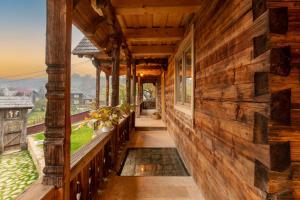 a porch of a wooden house with a view at Poieni 39 in Poienile Izei