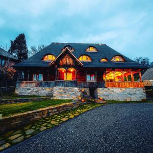 a large house with its lights on at Poieni 39 in Poienile Izei