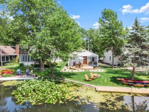 an aerial view of a house with a boat in the water at Adorable Wawasee Cottage in Oakwood Park in Syracuse