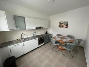 a kitchen with a table and chairs and a sink at Eine Wohnung zum wohlfühlen in Lübbecke