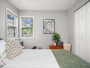 a bedroom with a white bed and a window at Adorable Wawasee Cottage in Oakwood Park in Syracuse