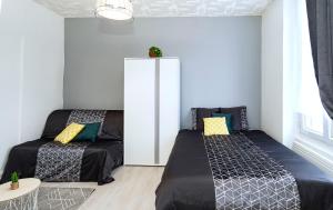 Posteľ alebo postele v izbe v ubytovaní LD-Location Hôtel