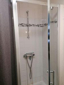 a bathroom with a shower with a glass door at Appartement cosy au Tréport 2 à 4 personnes in Le Tréport