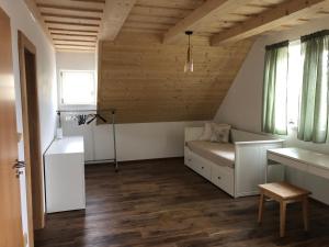 a small room with a couch and a table and window at Roubenka ARCHA in Dolní Morava