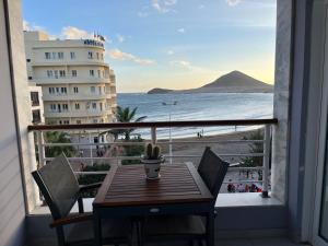 a table and chairs on a balcony with a view of the beach at Playa Grande, El Médano Best View in El Médano