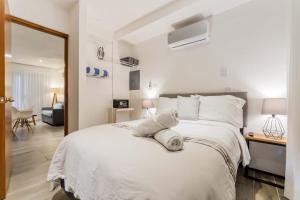 a bedroom with a white bed with towels on it at HotelZone L20 Beach Access in Cancún
