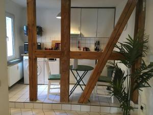 a kitchen with a table and chairs in a room at Nette Wohnung gute Austattung Parkplatz Terrasse in Greifswald