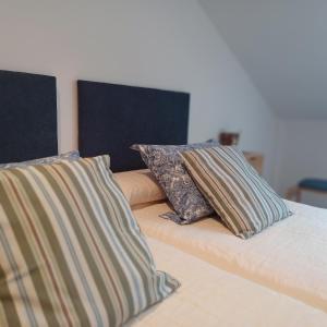 two pillows sitting on top of a bed at Apartamento Mar de Sal in Finisterre +13 photos