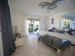 a living room with a couch and a table at Sublime Villa Piscine Jacuzzi Côte d'Azur in Mouans-Sartoux