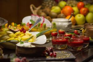 a table topped with plates of food and fruit at Royal Ours Blanc Boutique Hôtel & Spa in L'Alpe-d'Huez
