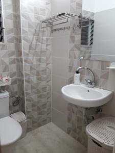 a small bathroom with a sink and a toilet at Private room in the сomfortable apartment in Ashdod, 7 min walk to the beach in Ashdod