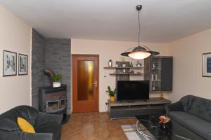 a living room with a couch and a flat screen tv at Apartment Gogo in Opatija