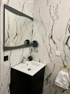 a bathroom with a sink and a mirror at R.Suite in Saint-Étienne