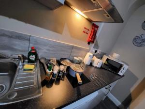 a kitchen with a counter top with a sink and a counter at Easy Living Nottingham - Burns Street in Nottingham