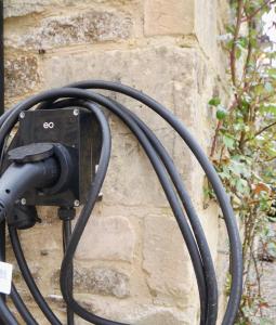 a hose hooked up to a stone wall at Beautiful self-contained Cotswolds Barn in Yatton Keynell