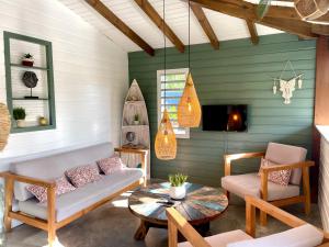 a living room with a couch and a table at Villa Ô Perchée in Pointe-Noire