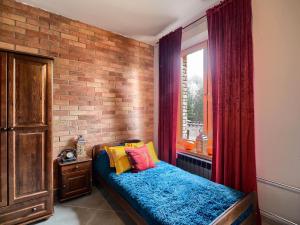 1 dormitorio con cama y pared de ladrillo en Leśna Baszta, 