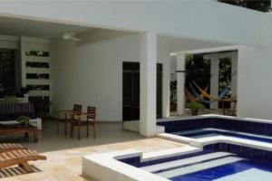 a swimming pool in the middle of a house at Casa Girardot in Ricaurte