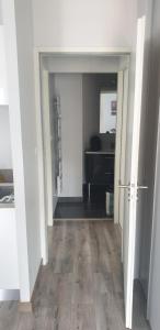 una habitación vacía con un pasillo que conduce a una habitación con una mesa en Appartement T2 45 m² en centre-ville, en Ax-les-Thermes