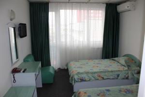 Ένα ή περισσότερα κρεβάτια σε δωμάτιο στο Rodopi Hotel
