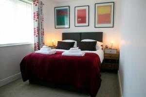 a bedroom with a bed with two towels on it at Wow I'm living on the beach. Luxury 4 bed sleeps 8 in Pagham