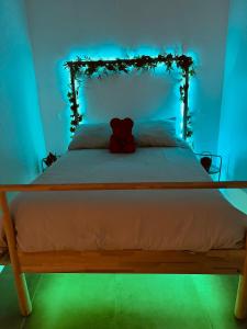 a bedroom with a bed with a teddy bear on it at SPA JUNGLE in Le Mesnil-Saint-Denis