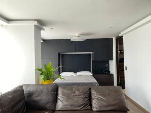 sala de estar con sofá y cama en Black Loft. Moderno y nuevo, súper ubicado., en Ciudad de México