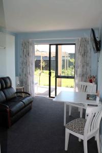 a living room with a white table and a couch at Marlborough Wine Country B&B in Blenheim