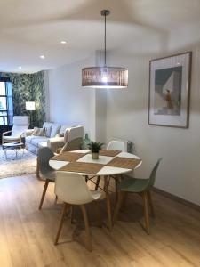 a dining room with a table and chairs and a couch at La plaza de llanes, Plaza Parres Sobrino, 6 in Llanes
