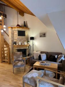 a living room with a couch and a fireplace at Apartman Jahorina-hotel Vucko in Jahorina