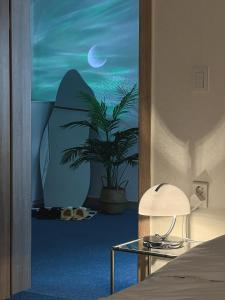 a bedroom with a painting of a surfboard and a plant at Modern K-style House in Seoul