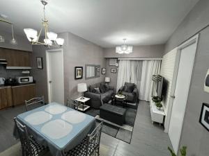 a living room with a table and a couch at Spacious 2 Bedroom condo unit for rent in Iloilo City