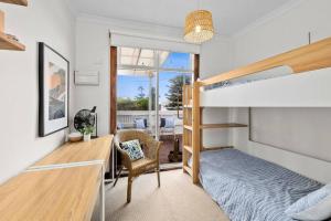 a bedroom with a bunk bed and a desk at Two houses from the beach 100m to Sand and Surf Sea Views in Torquay